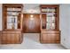 Hallway featuring built in bookcases and storage cabinets with decorative light fixture at 6339 Cornelia Dr, Douglasville, GA 30134