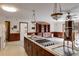 Open-concept kitchen featuring a center island cooktop and seamless access to the living area at 6339 Cornelia Dr, Douglasville, GA 30134