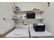 Practical laundry room equipped with a washer, dryer, and convenient shelving at 6339 Cornelia Dr, Douglasville, GA 30134
