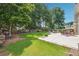 Large backyard with mature trees, lush lawn, outdoor seating, and a fire pit at 775 Gran Heritage Way, Dacula, GA 30019