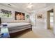 Bright bedroom with striped walls, tray ceiling, and carpet flooring with an attached full ensuite at 775 Gran Heritage Way, Dacula, GA 30019
