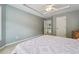 Bedroom with a tray ceiling, carpet floors, and open door to upstairs hallway at 775 Gran Heritage Way, Dacula, GA 30019
