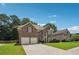 Beautiful brick home boasts a well-maintained lawn, two-car garage, and inviting exterior at 775 Gran Heritage Way, Dacula, GA 30019