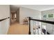 Bright upstairs hallway with neutral carpet and view overlooking the living area and backyard at 775 Gran Heritage Way, Dacula, GA 30019