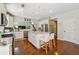 Bright kitchen features white cabinets, stainless steel appliances, and center island with granite countertops at 775 Gran Heritage Way, Dacula, GA 30019
