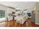 Bright kitchen features white cabinets, stainless steel appliances, and center island with granite countertops at 775 Gran Heritage Way, Dacula, GA 30019