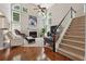 Bright living room with fireplace, large windows, and staircase at 775 Gran Heritage Way, Dacula, GA 30019