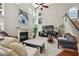Bright living room with fireplace, large windows, and staircase at 775 Gran Heritage Way, Dacula, GA 30019