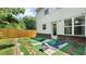 A landscaped backyard patio and lawn with a wood fence surrounding the property at 173 Oakland Hills Way, Lawrenceville, GA 30044