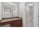 Bathroom featuring granite counters and a large mirror at 173 Oakland Hills Way, Lawrenceville, GA 30044