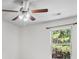 Neutral bedroom with a ceiling fan and large bright window with curtains at 173 Oakland Hills Way, Lawrenceville, GA 30044