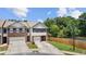 Well-maintained townhome with a manicured lawn and a privacy fence at 173 Oakland Hills Way, Lawrenceville, GA 30044
