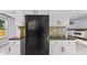 A kitchen featuring white cabinets, stainless steel appliances, and a backsplash at 173 Oakland Hills Way, Lawrenceville, GA 30044