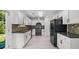 Spacious kitchen with granite countertops and white cabinets offering ample storage at 173 Oakland Hills Way, Lawrenceville, GA 30044