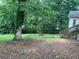 Backyard features mature trees, grass, and a privacy fence with access to a staircase at 1003 Valley Se Dr, Smyrna, GA 30080