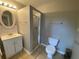 Practical bathroom featuring tiled floors, a mirrored sink, shower and toilet at 1003 Valley Se Dr, Smyrna, GA 30080