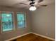 Well-lit bedroom showcasing hardwood floors and classic ceiling fan at 1003 Valley Se Dr, Smyrna, GA 30080