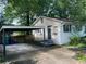 Exterior angle of home, showing carport, concrete parking area, back door, and siding at 1003 Valley Se Dr, Smyrna, GA 30080