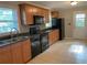 Functional kitchen featuring sleek black appliances and warm wooden cabinets, ready for culinary adventures at 1003 Valley Se Dr, Smyrna, GA 30080