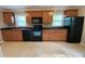 Functional kitchen featuring sleek black appliances and warm wooden cabinets, ready for culinary adventures at 1003 Valley Se Dr, Smyrna, GA 30080