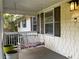 Close up of porch with swing, siding, windows, and a light fixture at 1003 Valley Se Dr, Smyrna, GA 30080