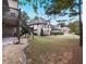 Expansive backyard with lush greenery, mature trees, and a neighboring house, offering a serene outdoor space at 1255 Mcminn Way, Snellville, GA 30078