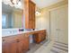Bathroom with dual vanities with a tall tower of drawers between and tile flooring at 1255 Mcminn Way, Snellville, GA 30078