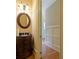 Bathroom with wood floors, granite vanity, decorative light fixture, and access to hallway at 1255 Mcminn Way, Snellville, GA 30078