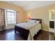 Comfortable bedroom with a queen bed, a large window with curtains, and hardwood floors at 1255 Mcminn Way, Snellville, GA 30078