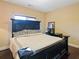 Cozy bedroom featuring a large dark-wood framed bed and dark-wood floors with simple decor at 1255 Mcminn Way, Snellville, GA 30078