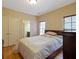 Bedroom with hardwood floors, closet, and natural light from window at 1255 Mcminn Way, Snellville, GA 30078
