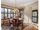 Sunlit dining room featuring shuttered windows, hardwood floors, and a wooden dining set with seating for six at 1255 Mcminn Way, Snellville, GA 30078