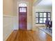 Inviting foyer with a solid wood front door, hardwood floors, and decorative molding leading into the dining room at 1255 Mcminn Way, Snellville, GA 30078