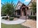 Beautiful stone home with a covered entryway and landscaped yard at 1255 Mcminn Way, Snellville, GA 30078