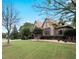 Charming stone home with a well-maintained lawn and mature trees creating a picturesque setting at 1255 Mcminn Way, Snellville, GA 30078