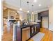 Open concept kitchen with center island, stainless steel dishwasher, and hardwood flooring at 1255 Mcminn Way, Snellville, GA 30078