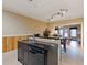 Modern kitchen island with sink, dishwasher, and granite countertops, complemented by wood paneling and tile flooring at 1255 Mcminn Way, Snellville, GA 30078