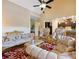 Luxurious living room featuring elegant gold-trimmed furniture, a high ceiling, and a view of the kitchen at 1255 Mcminn Way, Snellville, GA 30078