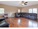 Large living room with hardwood floors, ceiling fan and oversized leather couch at 1255 Mcminn Way, Snellville, GA 30078