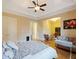 Spacious main bedroom suite with hardwood floors, a ceiling fan, and a seating area next to the bed at 1255 Mcminn Way, Snellville, GA 30078