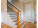 Staircase with wood steps, painted risers, and stained handrail at 1255 Mcminn Way, Snellville, GA 30078