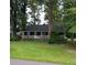 Charming single-story home featuring a cozy covered porch and a lush green front lawn at 2591 Perkerson Dr, Austell, GA 30168