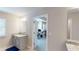 Bright bathroom featuring a vanity with granite countertop and an open doorway to a study area with neutral paint at 339 Cherryhill Ln, Woodstock, GA 30188