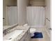 Neutral bathroom features a white shower curtain, vanity with granite countertop and a blue rug at 339 Cherryhill Ln, Woodstock, GA 30188