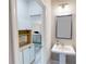 Pedestal sink in half bath adjacent to kitchen with built-ins at 339 Cherryhill Ln, Woodstock, GA 30188