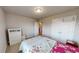 Well-lit bedroom with a double closet, a dresser and a colorful bedspread at 339 Cherryhill Ln, Woodstock, GA 30188