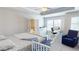 Bright bedroom with a ceiling fan, a connected bath and a work area near the window at 339 Cherryhill Ln, Woodstock, GA 30188
