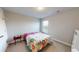 Comfortable carpeted bedroom with floral-patterned bedding, side table and ample natural light at 339 Cherryhill Ln, Woodstock, GA 30188