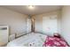 Neutral bedroom featuring a floral comforter, closet with mirrored doors, and adjacent door to the bathroom at 339 Cherryhill Ln, Woodstock, GA 30188