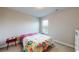 Comfortable carpeted bedroom with floral-patterned bedding, side table and ample natural light at 339 Cherryhill Ln, Woodstock, GA 30188